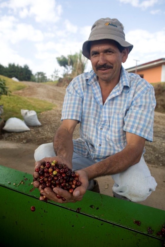 A coffee farmer with his coffee beans